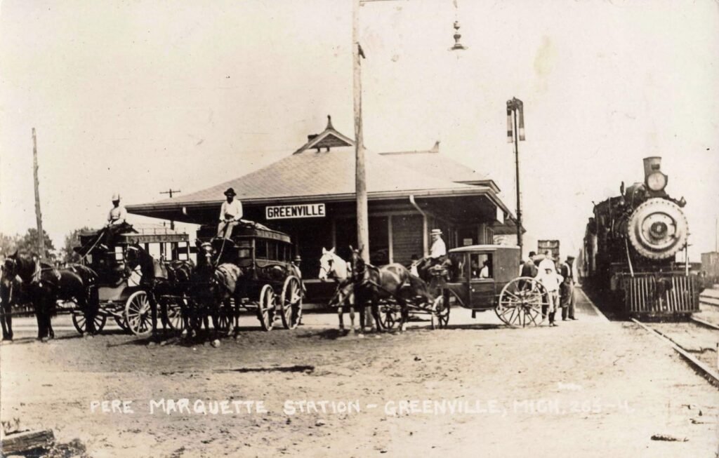 Stagecoaches pick up passengers at the Greenville depot.