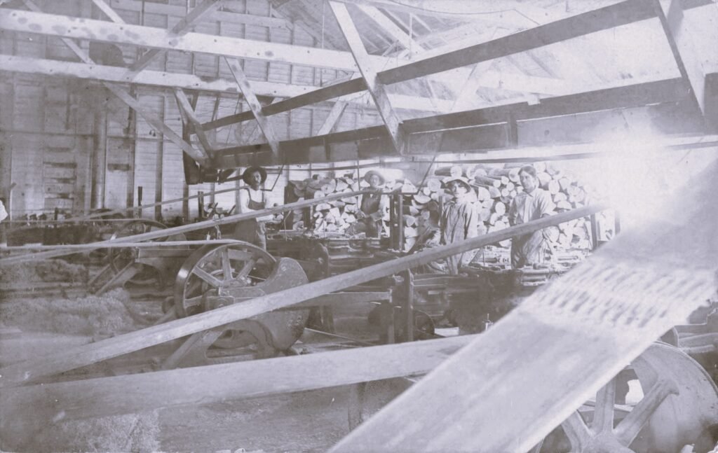 Historic factory with workers and machinery