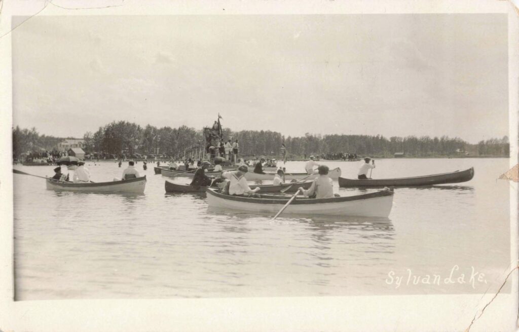 People rowing boats on lake