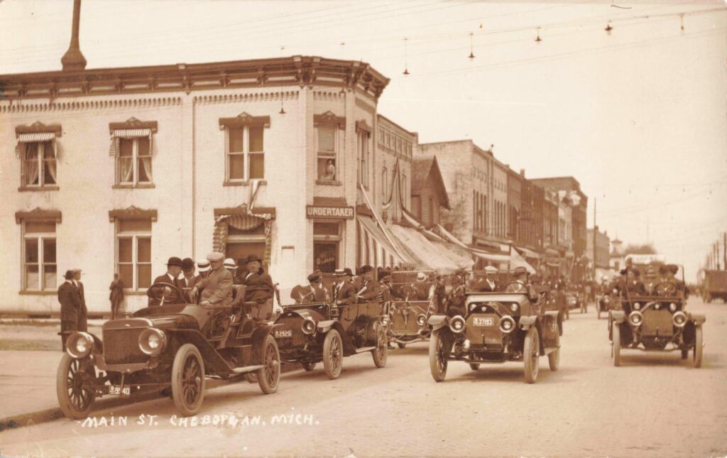 Historic street scene with vintage cars.