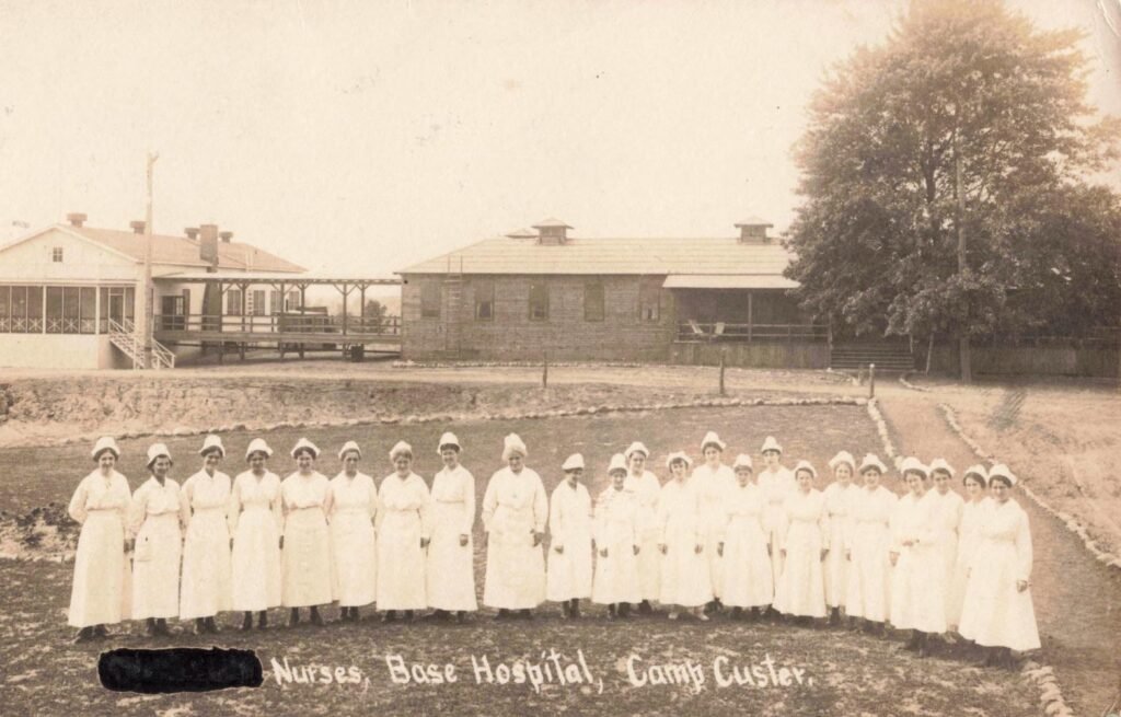Army nurses lined up outside the Camp Custer base hospital, part of a medical staff that treated training injuries, illness, and later wartime casualties.