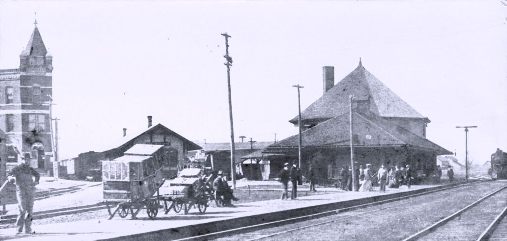 Historic train station with horse-drawn carriages