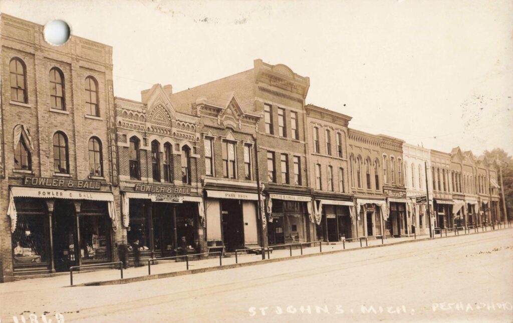 Main street storefronts with “Fowler & Ball.”