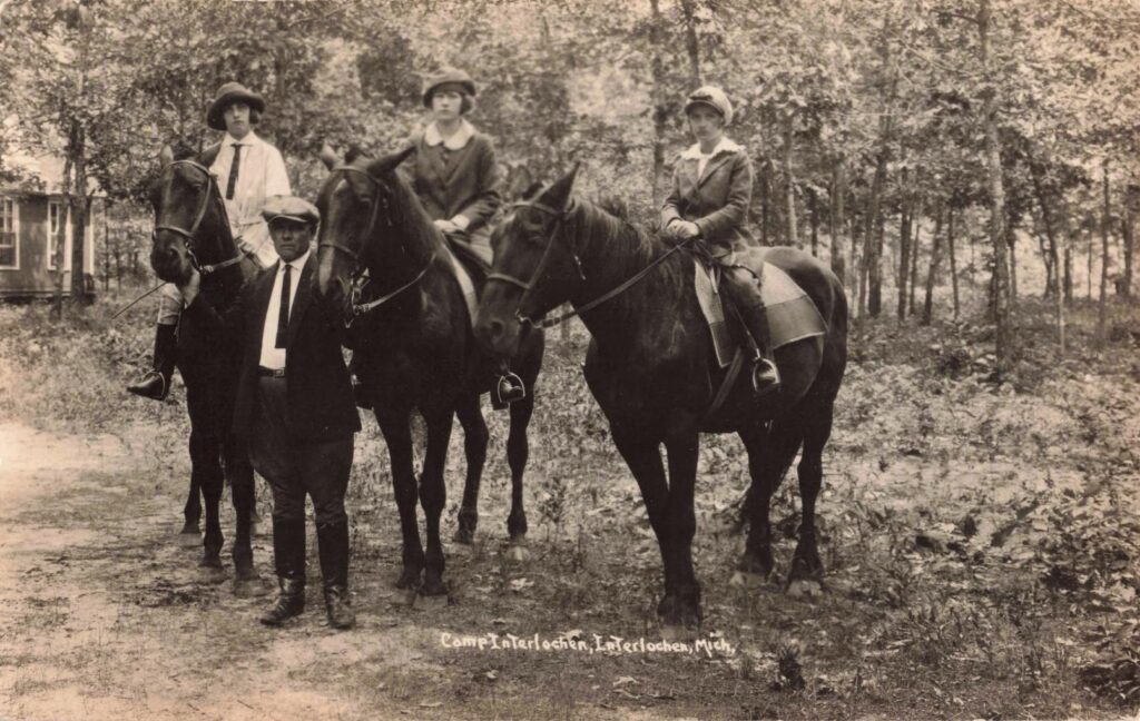  A horseback scene tied to camp life in the resort era, when summer was scheduled and supervised. 