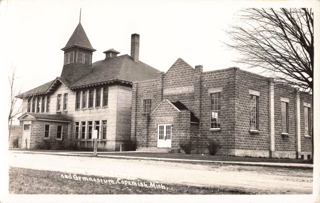 School and gym postcard view—the built scale signals a community planning for years ahead.
