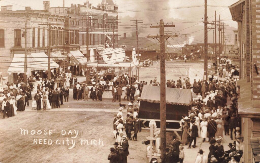 Historic street scene with large crowd