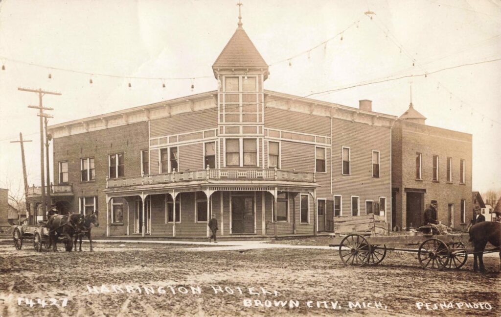 Historic hotel with horse-drawn carriages.