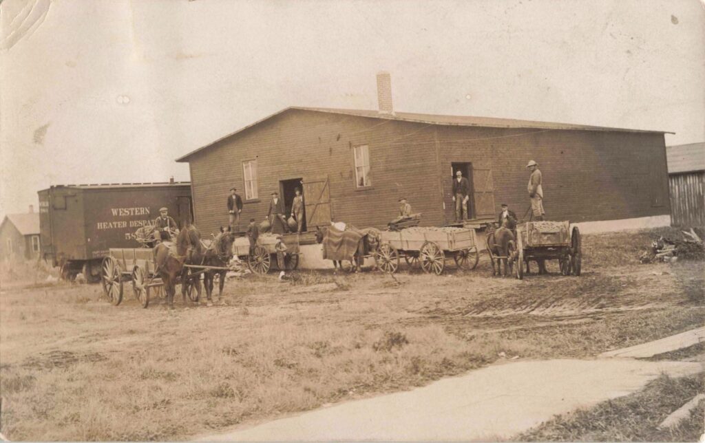 Historic scene with horse-drawn carts.