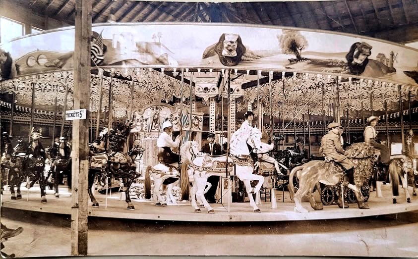 Vintage carousel with ornate horses.