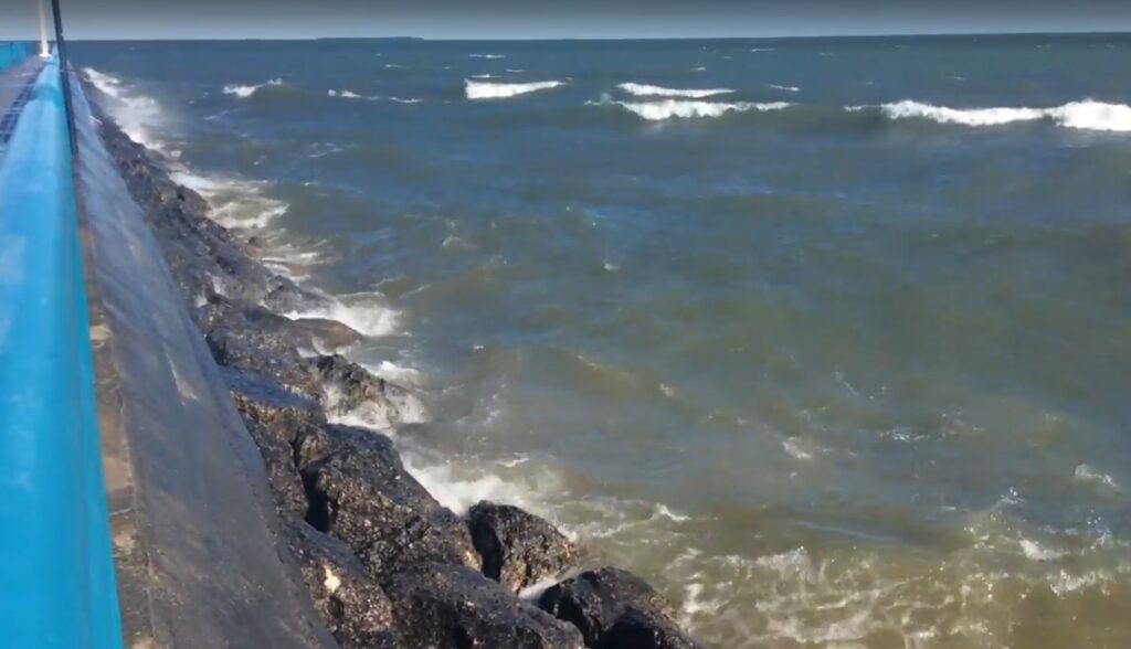 Waves crashing against rocky shoreline.