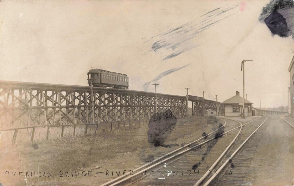 Wooden viaduct carrying interurban line across rural terrain.