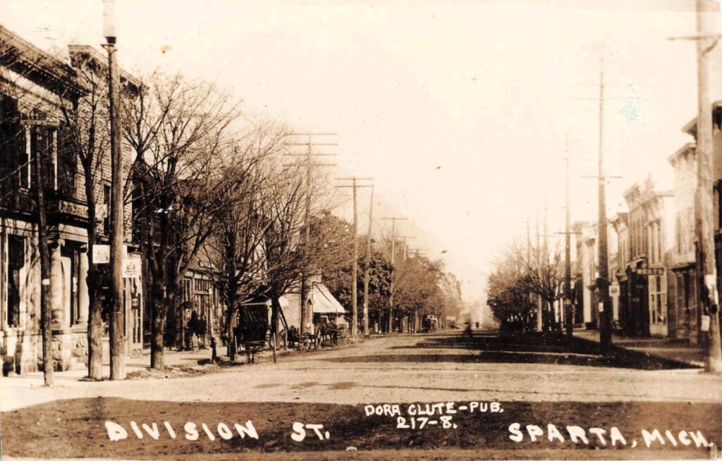 Division Street, dirt road with storefronts and wagons