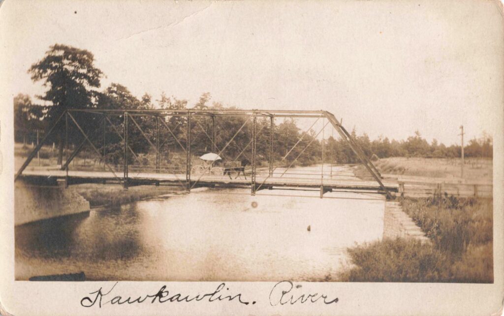 Another view of a bridge crossing the Kawkawlin River, highlighting the importance of reliable transportation links for farmers and traders.