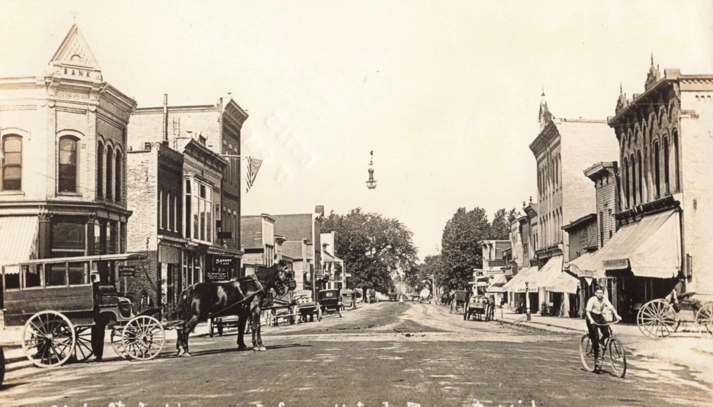 Historic street scene with horse-drawn carriages
