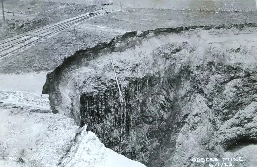 Mine collapse with exposed earth layers.