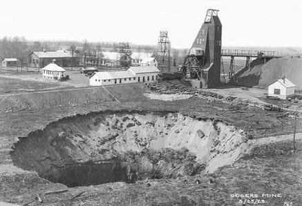 Large mine sinkhole with machinery