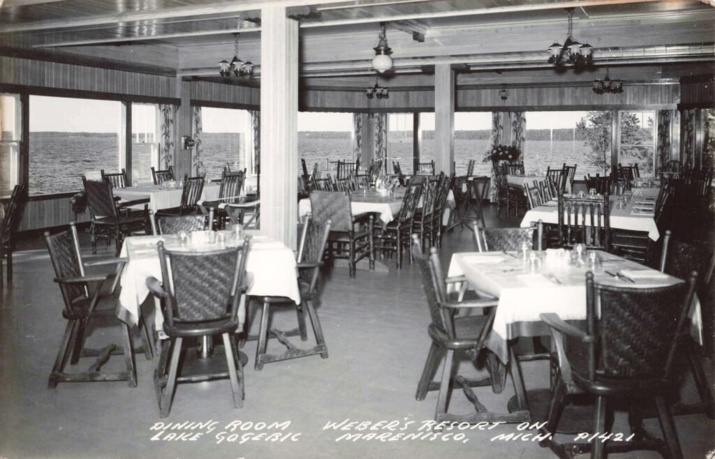 Interior dining room at Weber’s Resort on Lake Gogebic with tables, chairs and lake views.