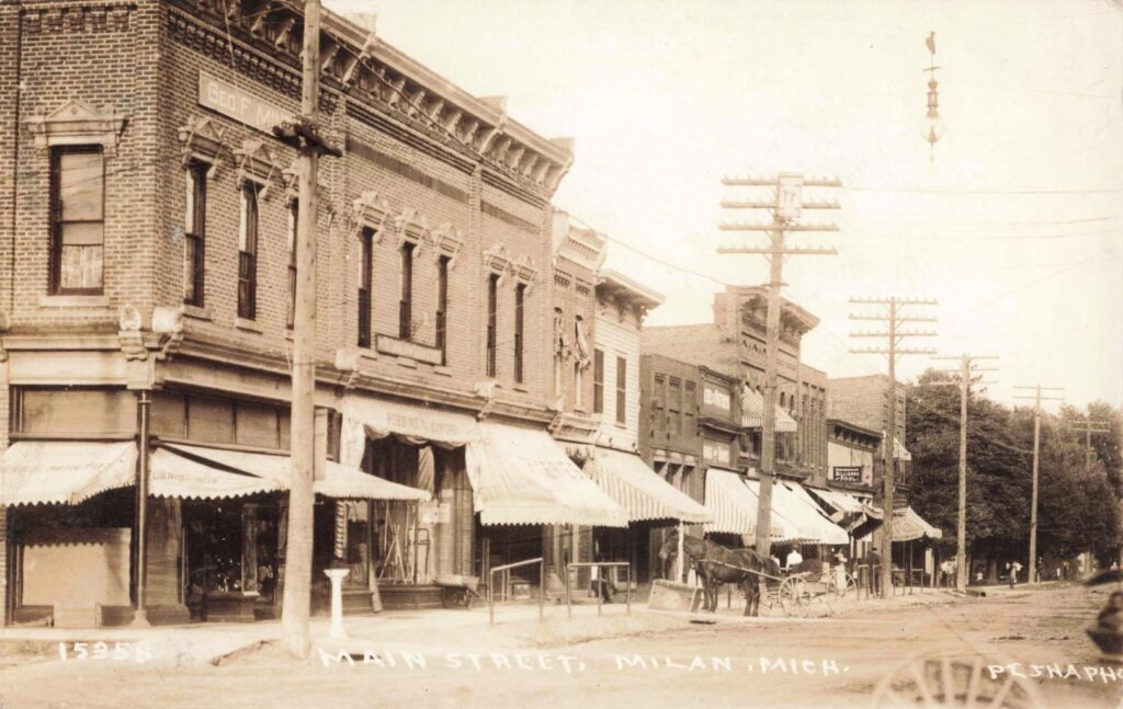 Historic street scene with horse-drawn carriage - history of Milan Michigan