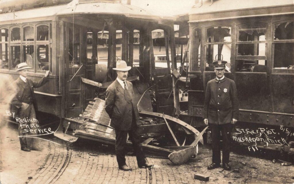 Close-up of wrecked electric streetcars in Muskegon following violent clashes during the 1919 Street Car Riot.