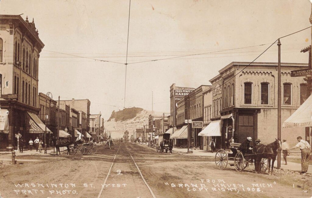 Historic street scene with horse-drawn carriages.