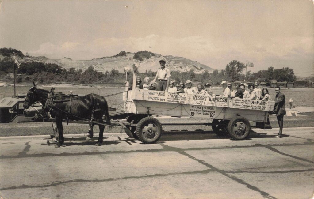 Horse-drawn wagon with passengers.
