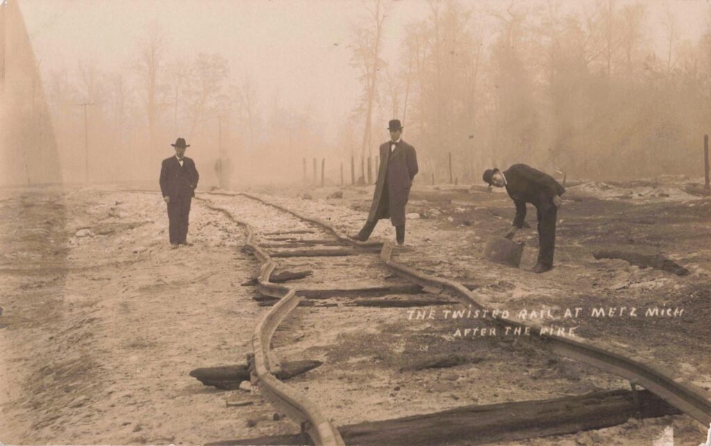 Twisted rails at Metz, Michigan, after the fire, showing how heat damaged the railroad line.
