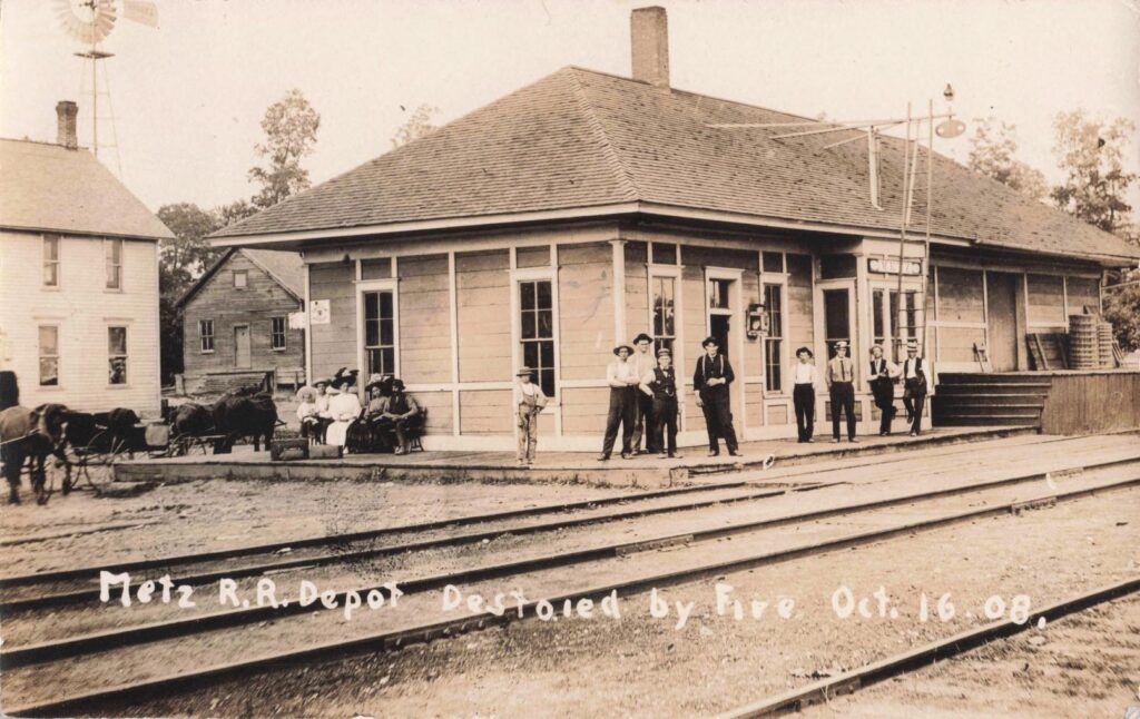 Detroit & Mackinac Railway depot at Metz, Michigan, dated Oct. 16, 1908, showing the depot setting tied to the fire story.
