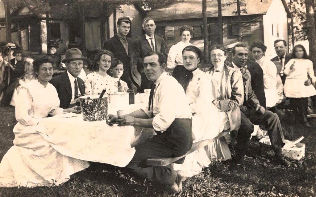 A table-ful of hungry folks, Indian Lake for Business Men’s Picnic, Aug. 4, 1910.