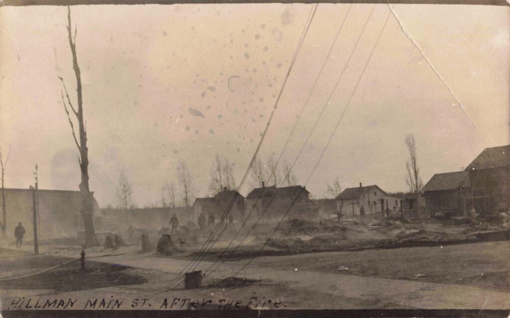 Main Street after a fire shows the damage that early Hillman residents had to face before rebuilding their business district.