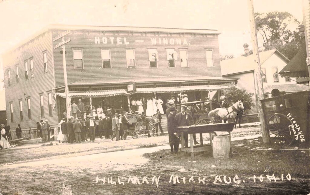 The Winona Hotel, seen with horses and a carriage, shows Hillman as a stop for travelers before cars became common.