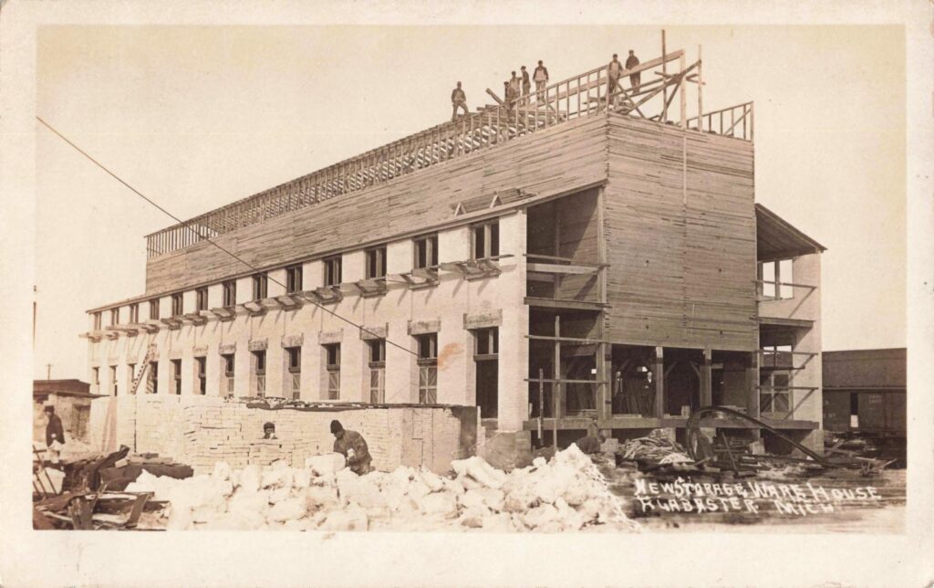 Workers build a new storage warehouse after the fire, showing the speed of the rebuilding effort.