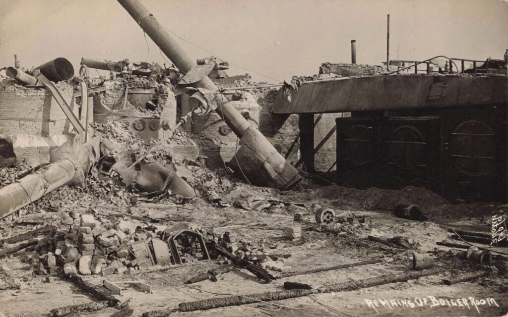 Twisted pipes, brick and machinery mark the boiler room ruins after the October 1910 fire.