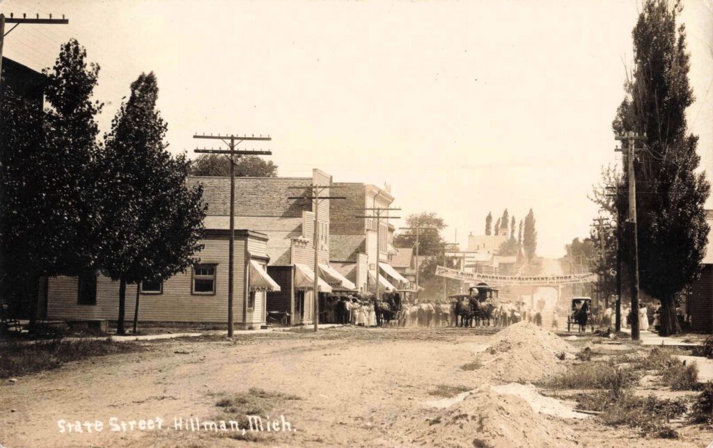Historic street scene with horse-drawn carriages.