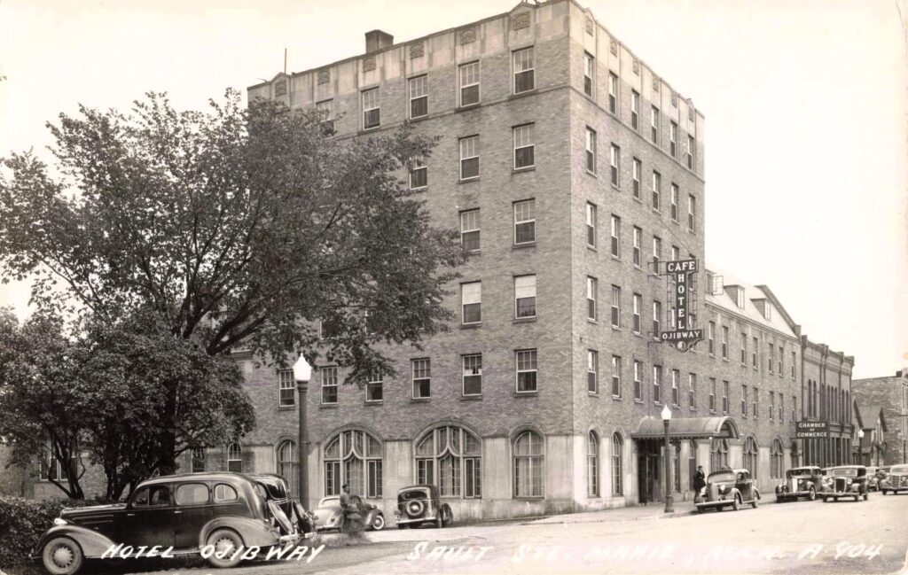 Historic hotel with vintage cars.