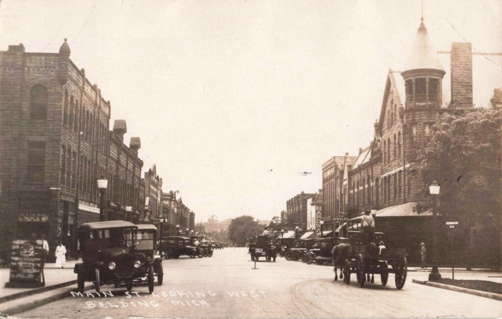 Early Main Street view with Belding Block and turreted building of the Belding Hotel.