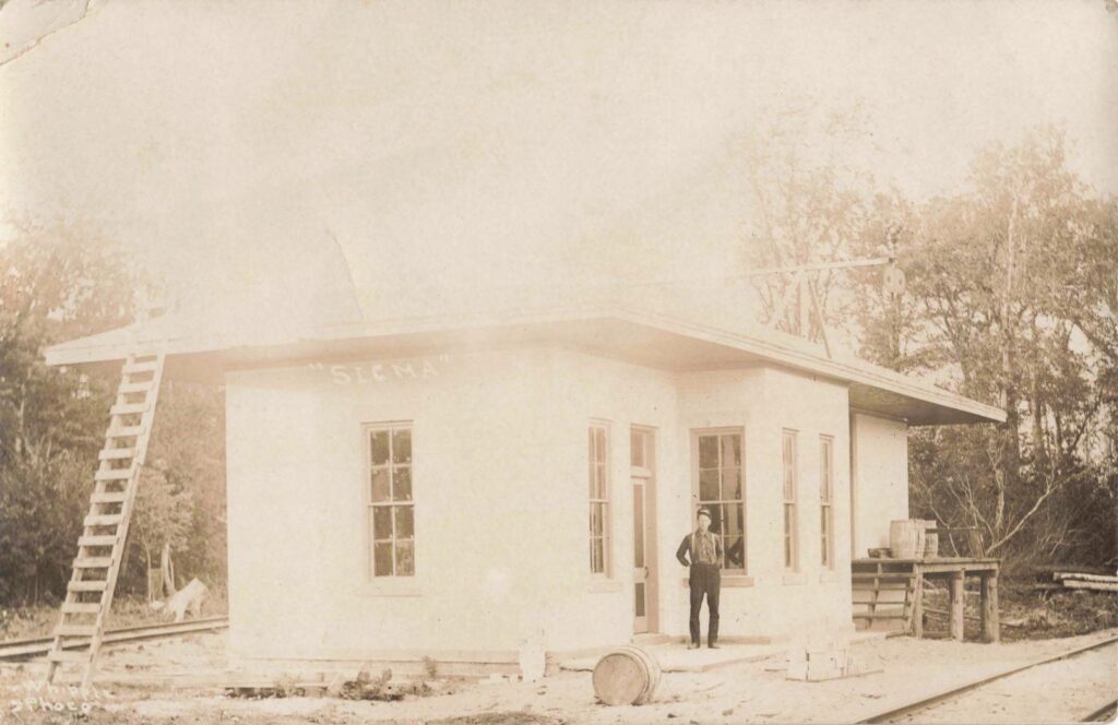 Sigma Depot, early 1900s: A man stands outside the depot, a key building in a town whose rise depended on rail service and the timber trade in Kalkaska County.