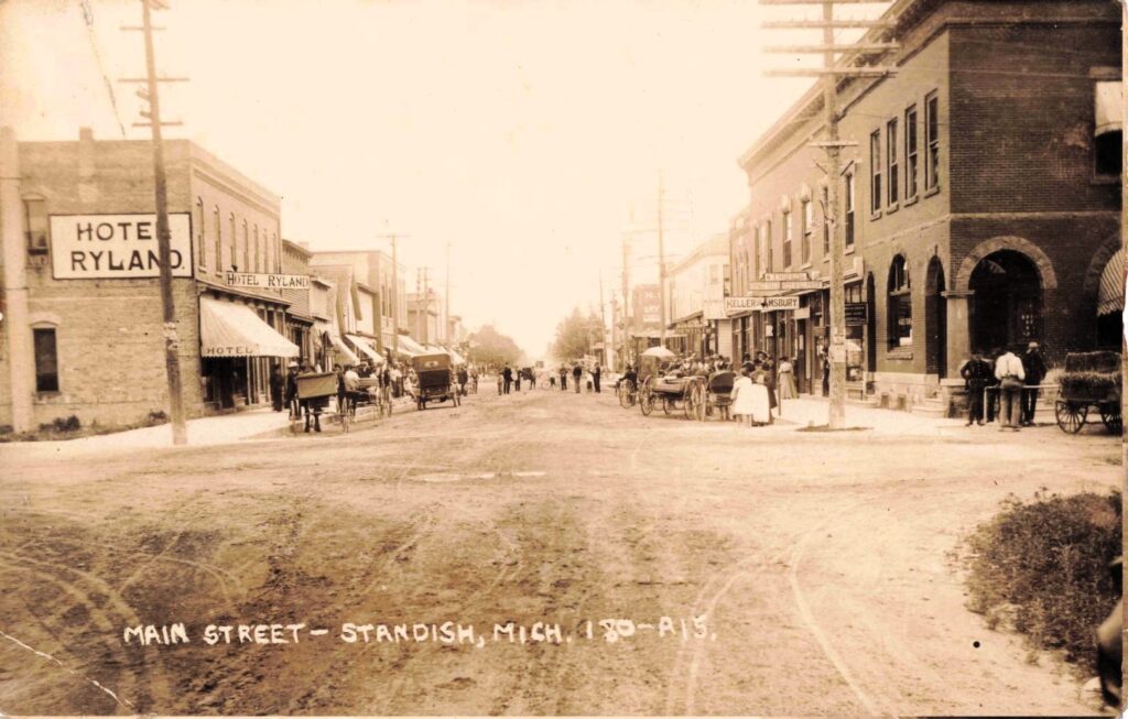 Main Street, Standish. Hotel Ryland, Keller & Amsbury and other businesses show the town’s busy commercial core.