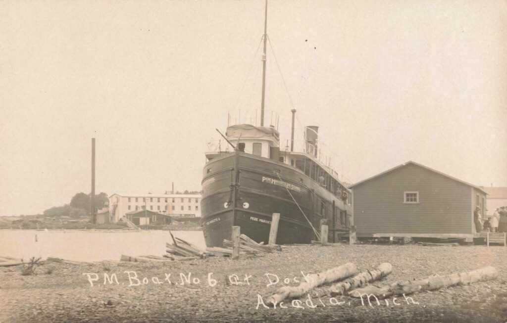 Historic ship docked near buildings.