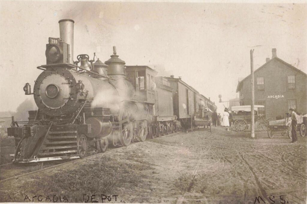 Arcadia depot, early 1900s. A steam locomotive and wagons show the inland side of the Pere Marquette dock system.