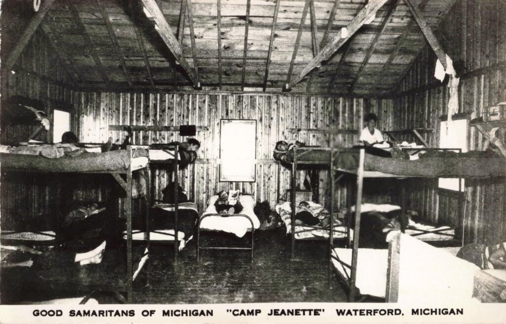 Boys inside a bunk cabin show the simple sleeping quarters that made a free two-week camp stay possible.
