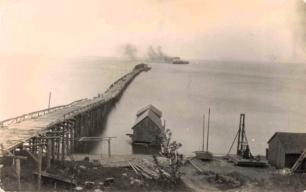 Old wooden pier by calm water