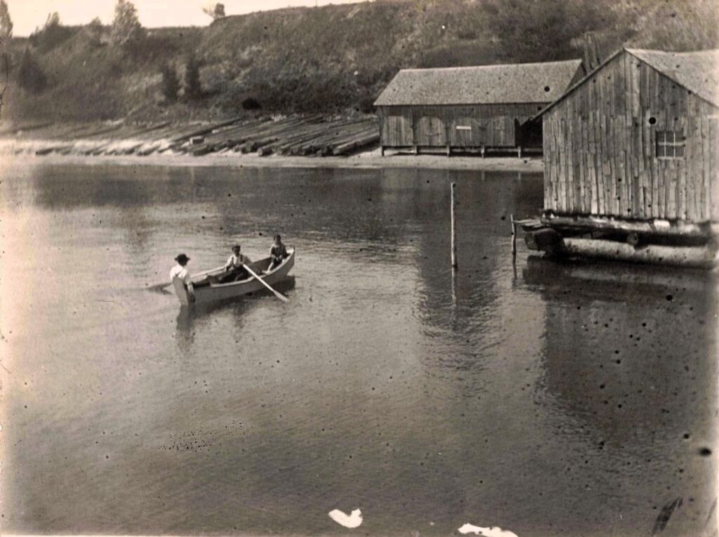  Small boats and shore buildings show the daily fishing culture that remained after the dock’s freight role declined.