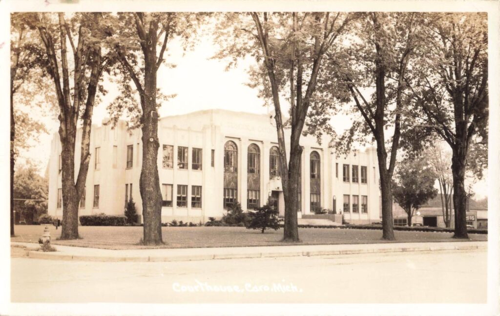 Historic courthouse surrounded by trees.