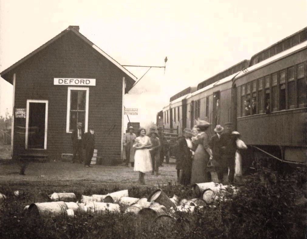 Train station with people and barrels