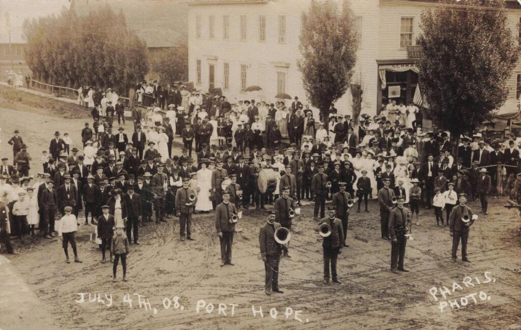 Port Hope Michigan band standing in a street during a Fourth of July celebration in 1908