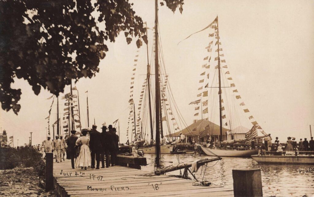 Sailboats decorated with signal flags at the Monroe piers in Michigan on the Fourth of July in 1907