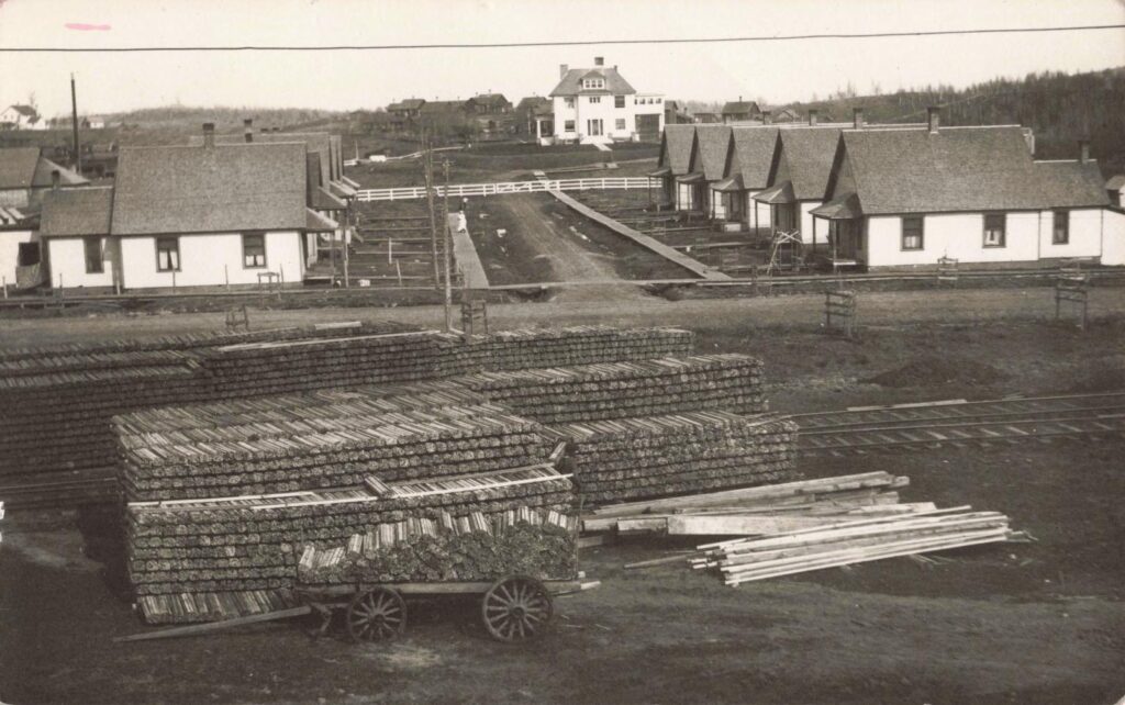  Stacks of cut lumber beside railroad tracks in Trout Creek Michigan in 1915.