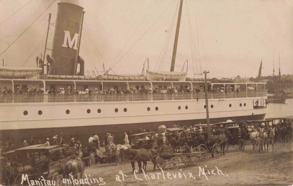 Steamboat unloading passengers at dock.