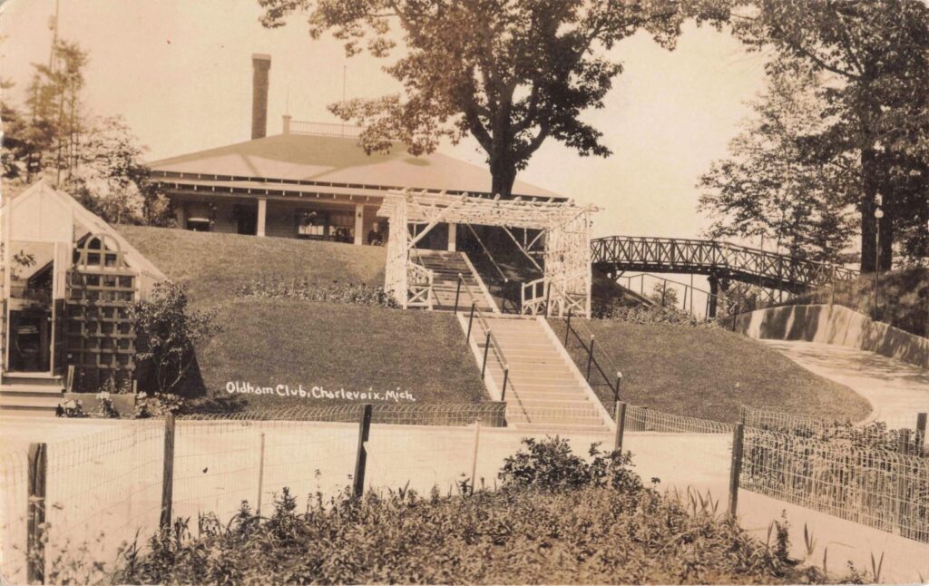 Historic club building with surrounding landscape.