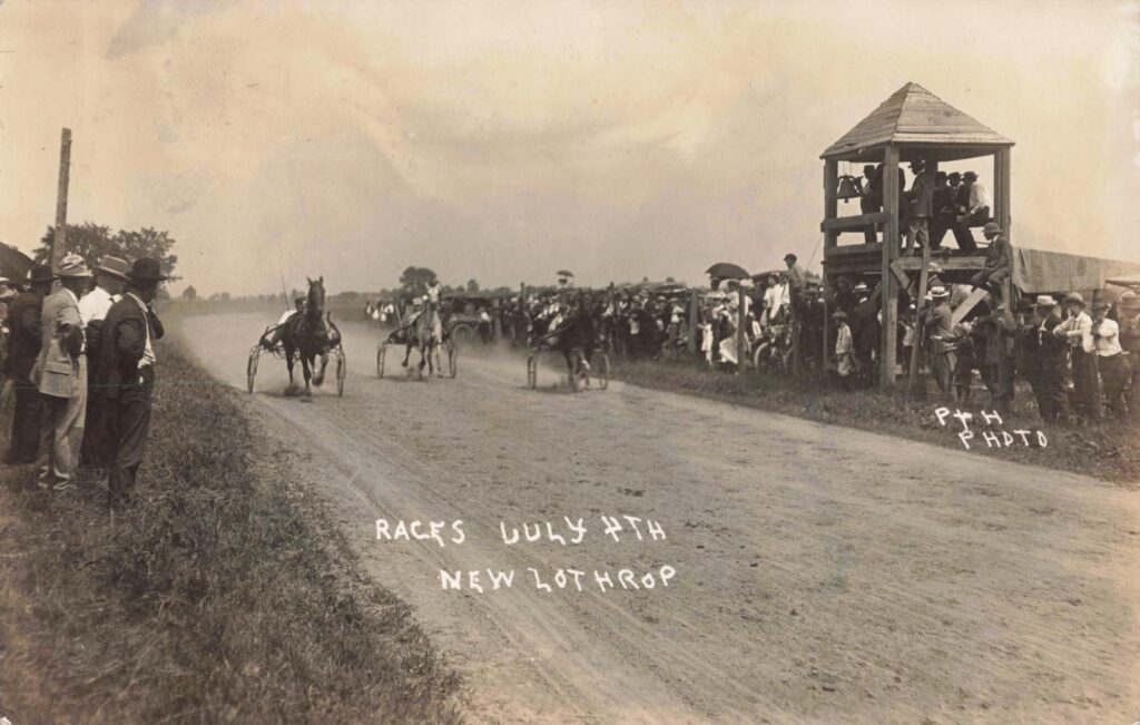 Harness racing on a dirt road during the Fourth of July celebration in New Lothrop Michigan in 1914